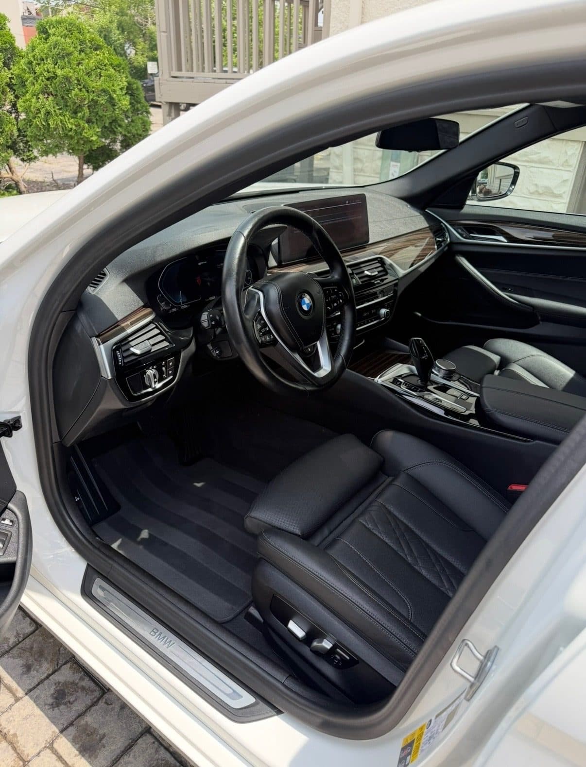 Spotless black leather interior of a BMW 5 Series after a full detail